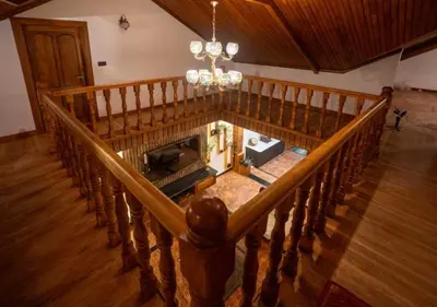 an overhead view of a room with a wooden staircase at Mandarin Orchid Resort in Kotagiri