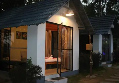 a small house with a glass door at The Wildcamp - Coorg in Kushālnagar
