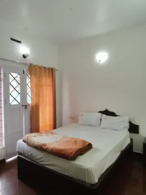a bedroom with a bed with a blanket on it at Kurinji home stay munnar in Munnar