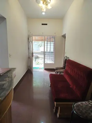 a living room with a red couch and a window at Kurinji home stay munnar in Munnar