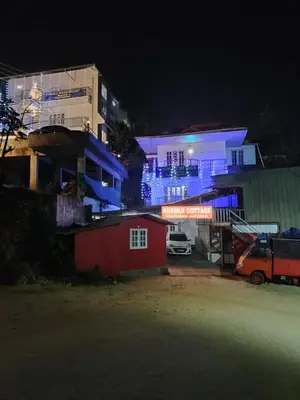 a group of buildings at night with blue lights at Kurinji home stay munnar in Munnar