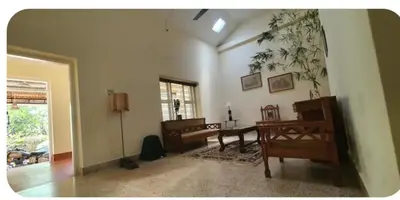 a living room with a table and a desk at Nakoor volkot in Suntikoppa