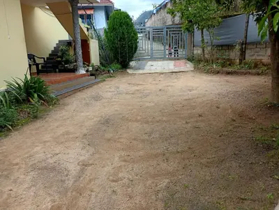 a dirt yard in front of a house at Enjoy home stay in Vattavada
