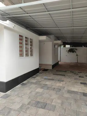 an empty room with a white wall and a ceiling at Ivory Suites County in Kozhikode