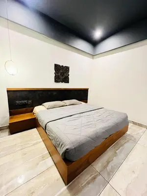 a bedroom with a large bed in a room at oakden lakkidi villa vythiri villa wayanad in Vythiri