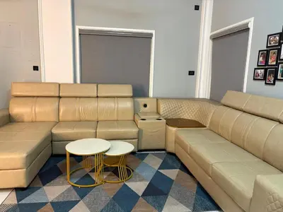 a living room with a couch and a table at Evania Pool Suites in Nedumbassery