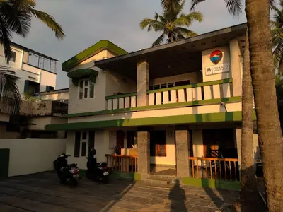 a building with two motorcycles parked in front of it at Thekkini rooms and Dorms in Kozhikode