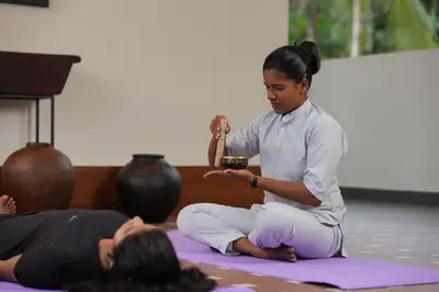 a woman sitting on the floor in a yoga class at Vaigayi Ayurveda Resort in Kodanad
