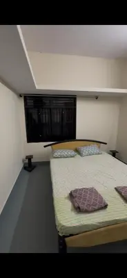 a bedroom with a bed with two pillows on it at Offline Resort in Bengaluru, Karnataka