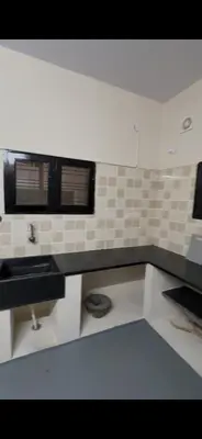 a white kitchen with a sink and a window at Offline Resort in Bengaluru, Karnataka