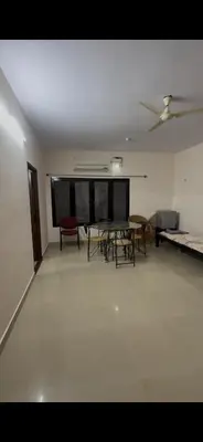 a room with a table and chairs in it at Offline Resort in Bengaluru, Karnataka