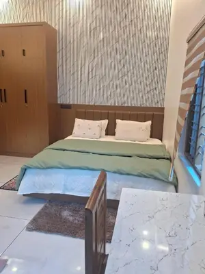 a bedroom with a large bed with a wooden headboard at blue Mount stay in Gūdalūr