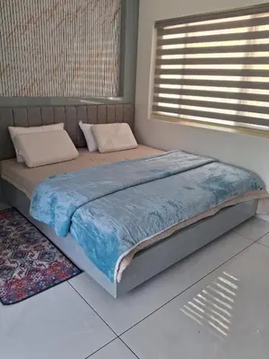 a large bed in a bedroom with a window at blue Mount stay in Gūdalūr