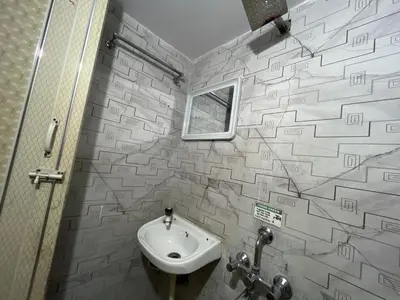 a bathroom with a sink and a mirror at G S Rooms Mysore in Mysore
