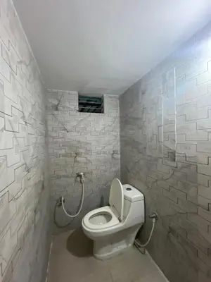 a bathroom with a white toilet in a room at G S Rooms Mysore in Mysore