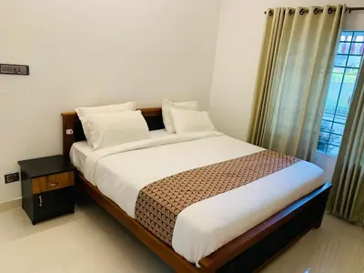 a bedroom with a bed and a window at Ocean pearl homestay-Manjeri in Malappuram