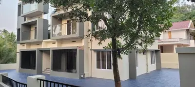 a building with a tree in front of it at Ocean pearl homestay-Manjeri in Malappuram