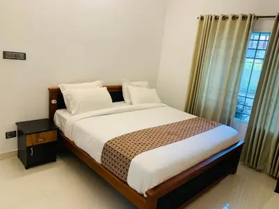 a bedroom with a bed and a window at Ocean pearl homestay-Manjeri in Malappuram