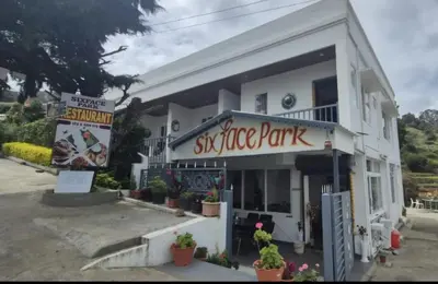 a building with a sign for a shrimp park at IndivaStays - Sixface Park in Ooty