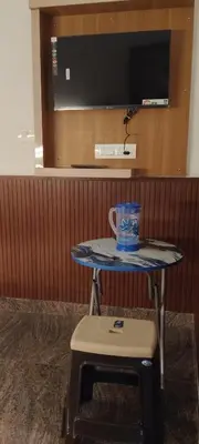 a table with a cup sitting on top of it at Thendral Stay Marayoor in Marayoor