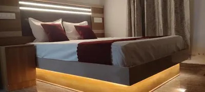 a bedroom with a large bed with red pillows at Thendral Stay Marayoor in Marayoor