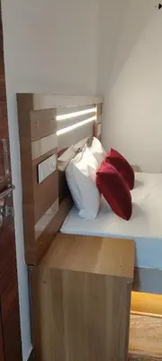 a bed with two pillows sitting on top of it at Thendral Stay Marayoor in Marayoor