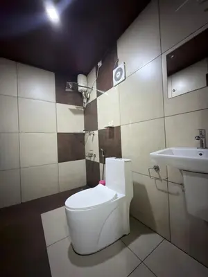 a bathroom with a toilet and a sink at Aditi By Greenleaves Resort Vythiri in Vythiri