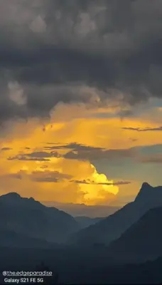 a sunset with mountains in the background at The EDGE Paradise in Neriyamangalam