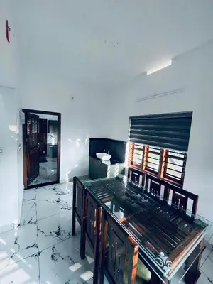 a room with a mirror and a wooden dresser at Stay loop in Cherambādi