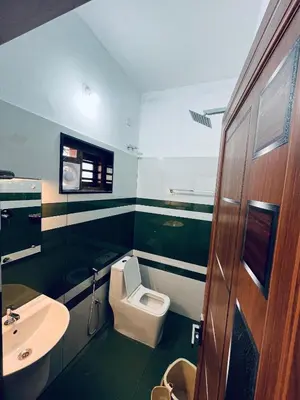 a bathroom with a toilet and a sink at Stay loop in Cherambādi