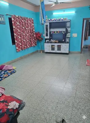 a room with a blue wall and a room with a floor at Joyful Homestay in Mysore
