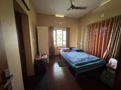 a bedroom with a bed and a window in a room at Puranattukara- Serene Stay by the Rice Fields in Trichūr