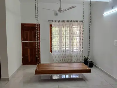 a swing in a room with a window at Mellow Villa cochin airport in Angamali