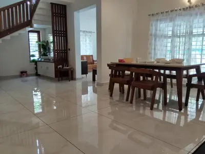 a dining room with a table and chairs at Mellow Villa cochin airport in Angamali