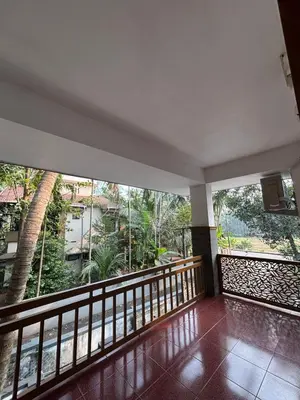 a room with a balcony with large windows at Sawan house in Tāzhekkod