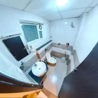 a large bathroom with a sink and a toilet at Gokulam Suits Guruvayur in Guruvāyūr