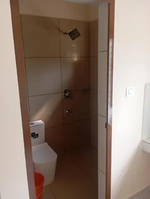 a bathroom with a toilet and a shower at PURAYIL Rooms in Kozhikode