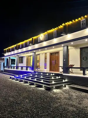 a building with stairs in front of it at night at Luxury Garden Villa, Free Breakfast in Guruvayoor in Manattala
