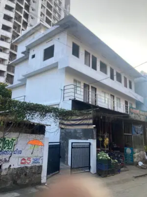 a white building with an umbrella in front of it at vhost in Alwaye