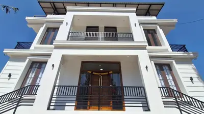a tall white building with a staircase in front of it at BVista Kodaikanal in Kodaikānāl