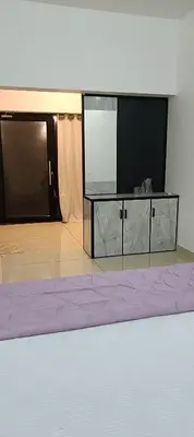 a large entertainment center with a large screen in a room at Metta Heaven in Kodenchery