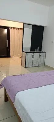 a bedroom with a bed and a flat screen tv at Metta Heaven in Kodenchery