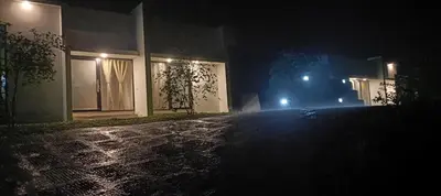 a house at night with lights on a street at Metta Heaven in Kodenchery