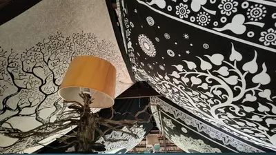 a lamp sitting on a table next to a wall at Heritage Mudhouse Homestay in Virajpet