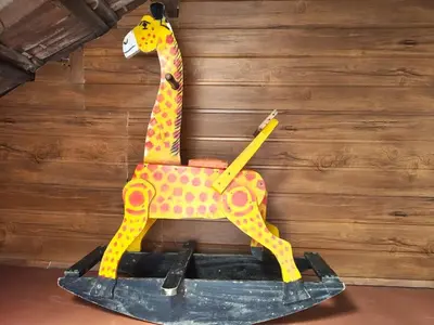 a giraffe toy sitting on top of a table at Heritage Mudhouse Homestay in Virajpet
