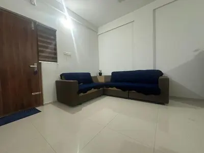 a living room with a couch and a door at 1bhk Kalp 200m temple Thulasi nagar in Guruvāyūr