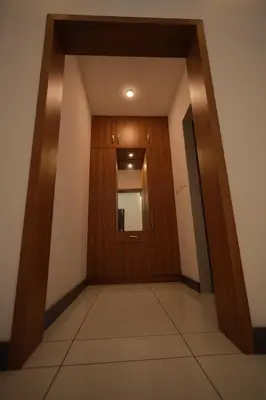 a hallway with a wooden door in a building at Kadmane Resort in Kākankote