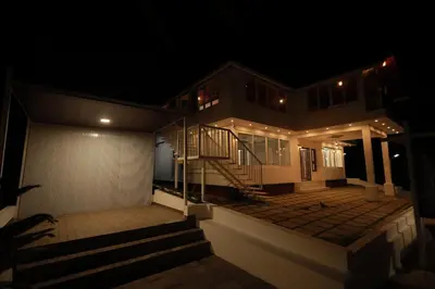 a house at night with the lights on at Kadmane Resort in Kākankote