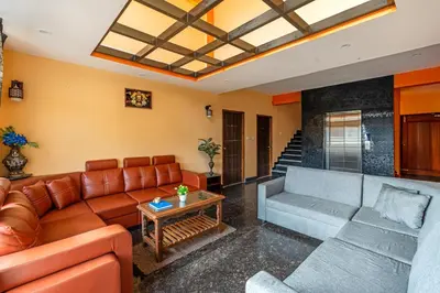 a living room with a couch and a table at Orchid Villa Kotagiri in Kodanād