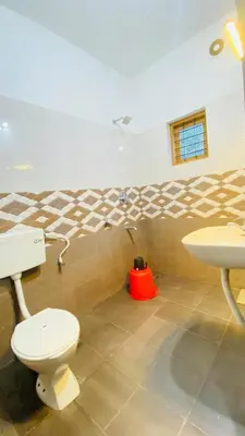 a bathroom with a toilet and a sink at The Wayanad Stays in Kalpetta